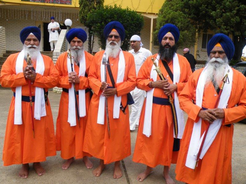 Panj Pyare in front of the original Gurdwara building on Logan Road