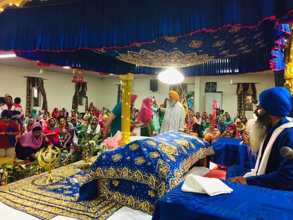 Sri Guru Granth Sahib Ji in Parkash with the sangat seated in the Darbar Sahib